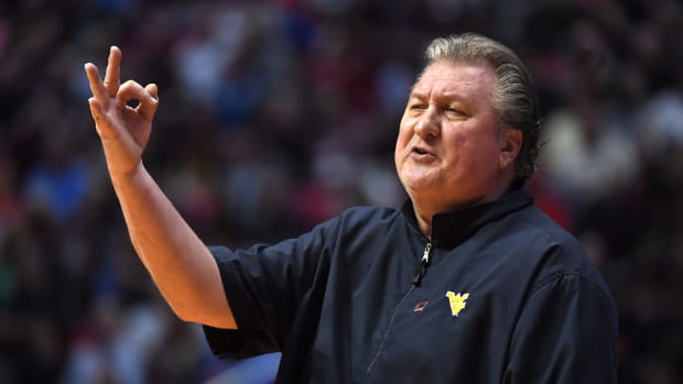 Bob Huggins making an "ok" sign with his fingers