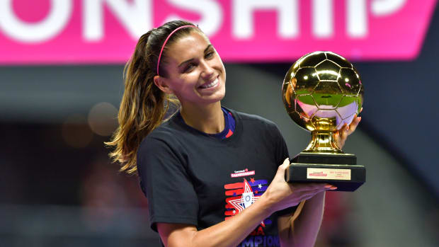 United States women's national team star Alex Morgan on the pitch receiving an award.